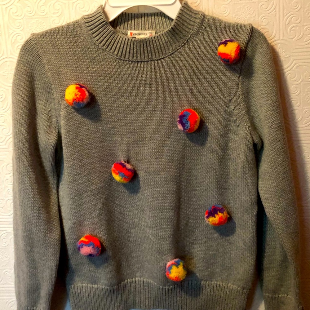 Crewcuts sweater with pom poms.